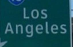 A portion of a guide sign showing two lines of legend with inadequate space between the lines.