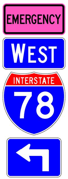 A sign assembly comprised of a white-on-blue directional arrow auxiliary sign above which is a full color Interstate route shield sign above which is a white-on-blue cardinal direction auxiliary sign above which is a supplemental plaque with the legend "Emergency" in black letters on a fluorescent pink background.